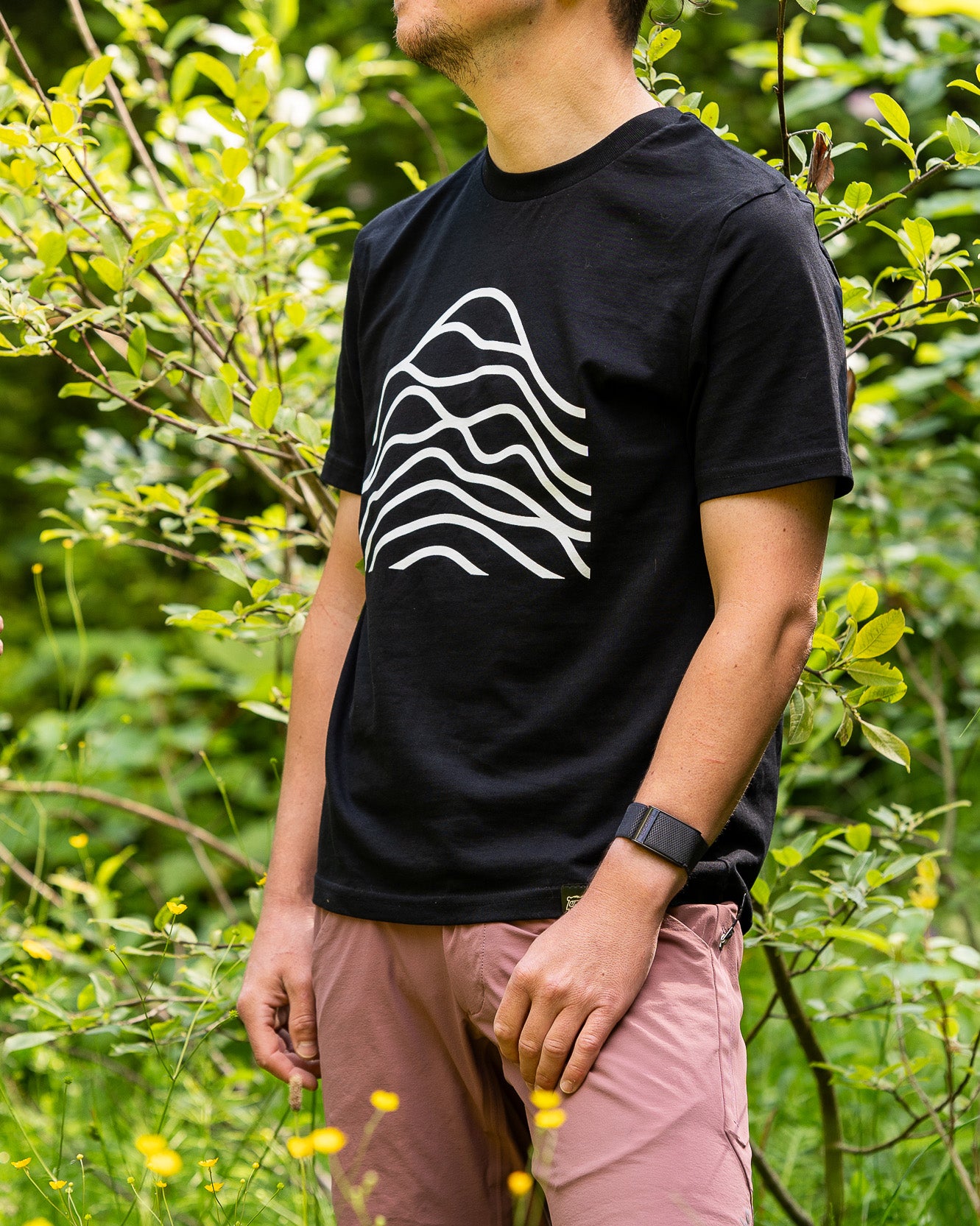 A black cotton t-shirt with a white graphic design in the center.