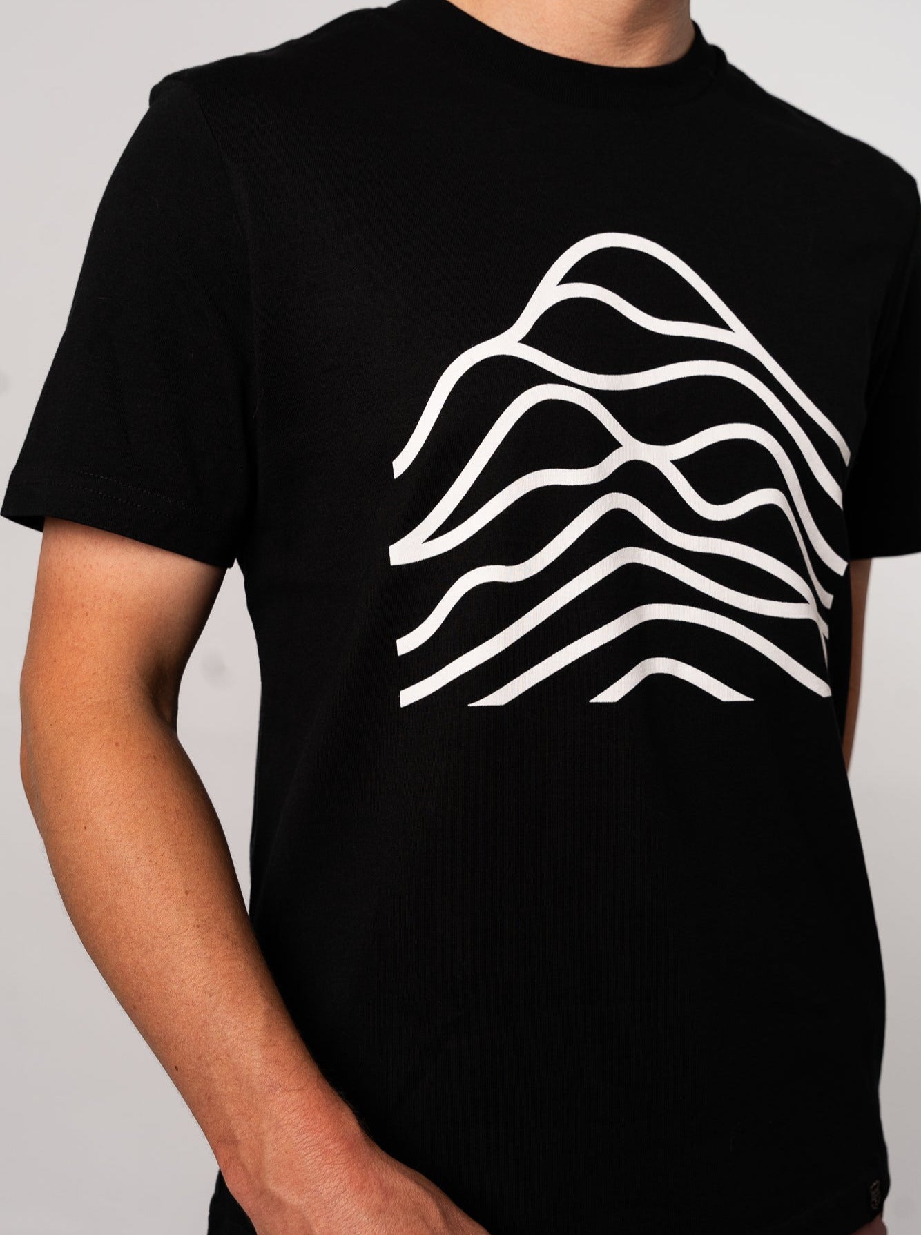 A black cotton t-shirt with a white graphic design in the center.