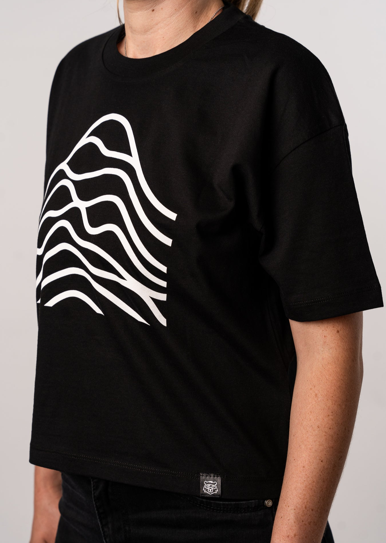 A black cotton t-shirt with a graphic design in white.